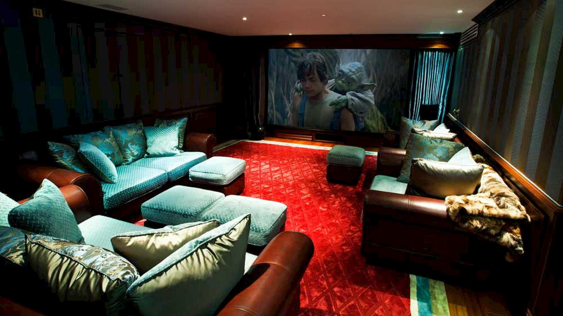 Home cinema with screen, curtains and projector.