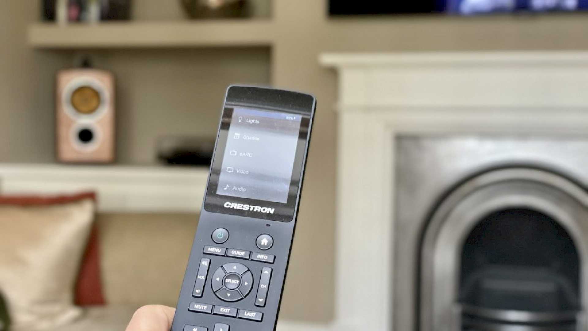 Crestron touchpanel remote being used to control media room.