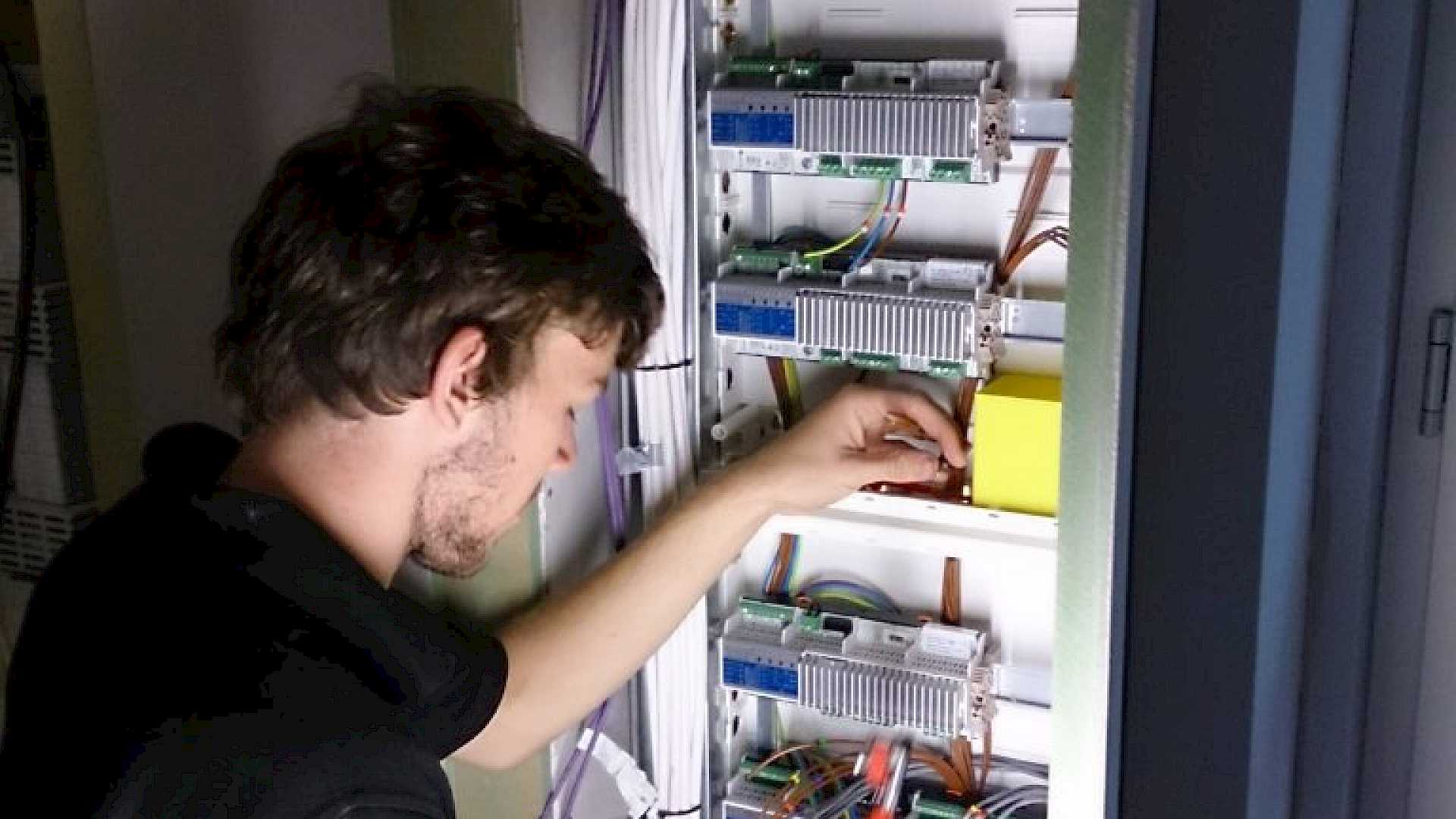 Engineer working on panel with Lutron dimmer.