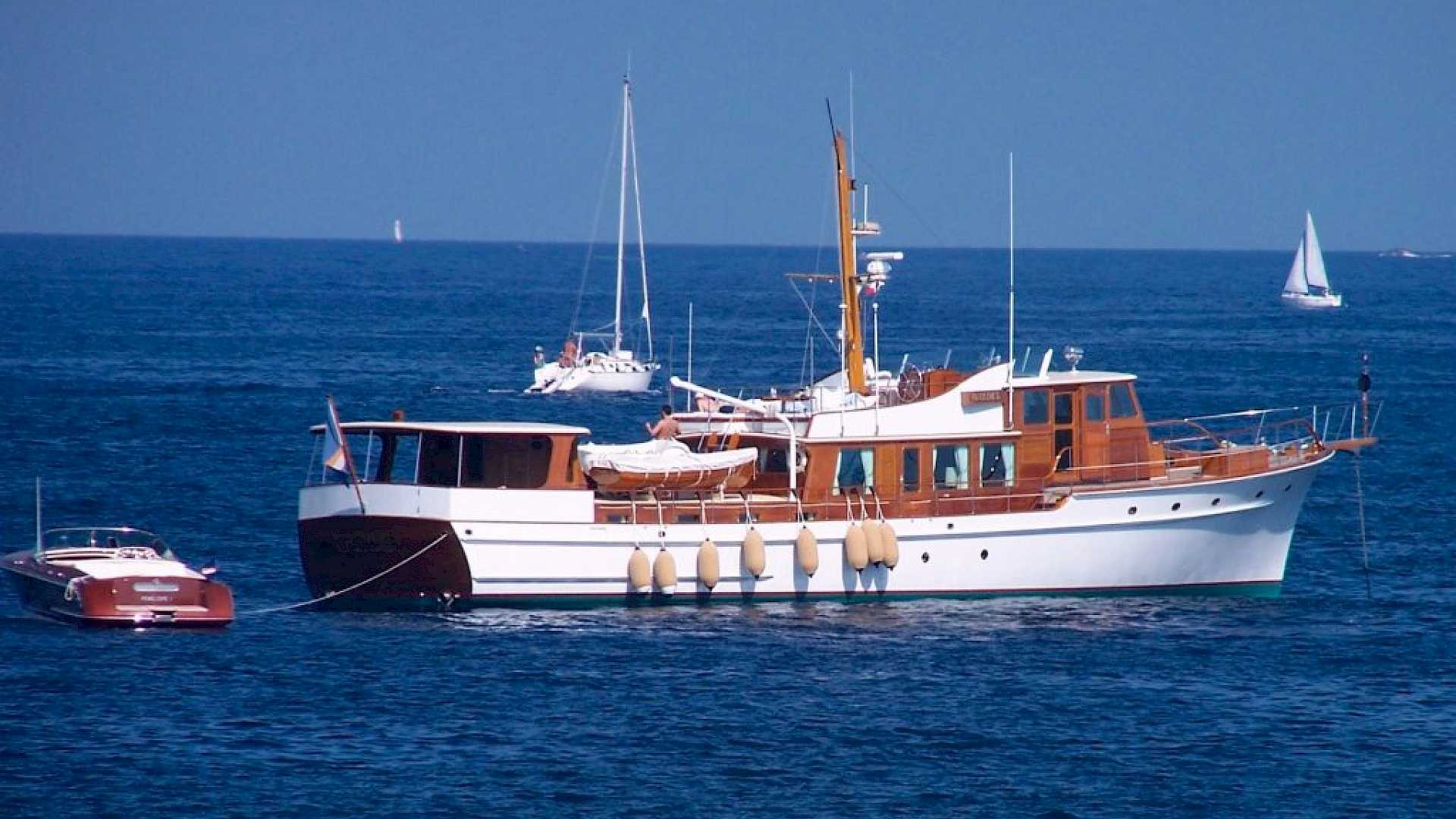 Shows yacht at sea, with marine audio visual system including video server, cinema and audio system.