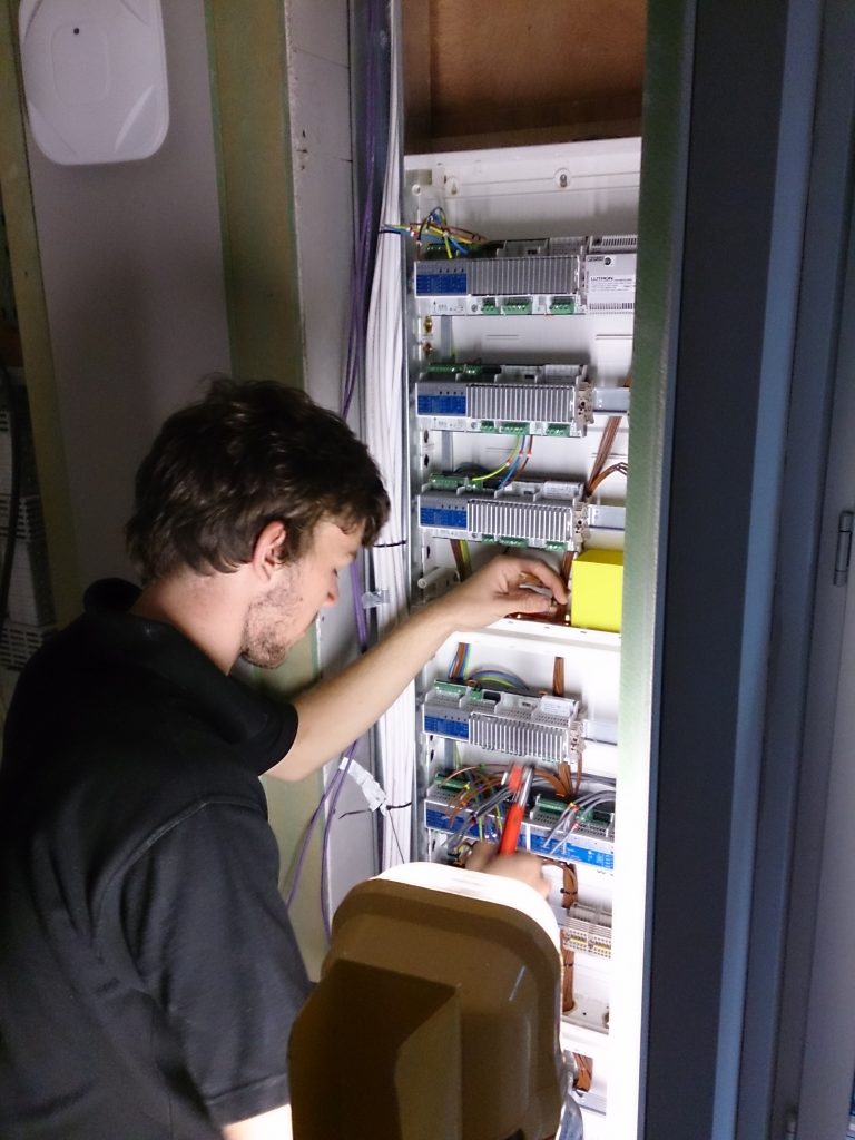 Engineer working on panel with Lutron dimmer.