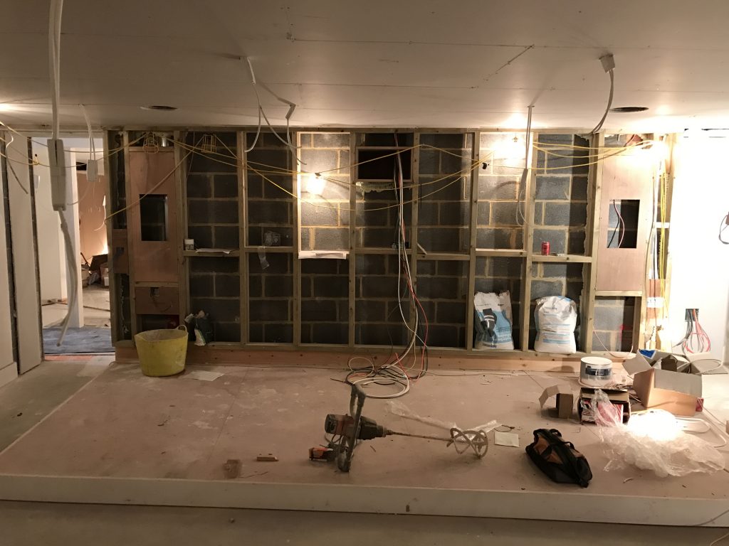 Image shows construction of rear wall of home cinema and wiring.