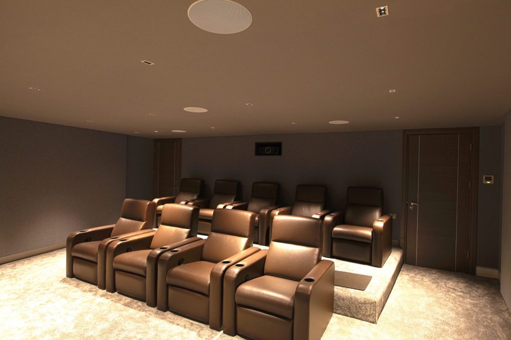 View to rear of immersive home cinema, shows Fortress seating and Barco projector.