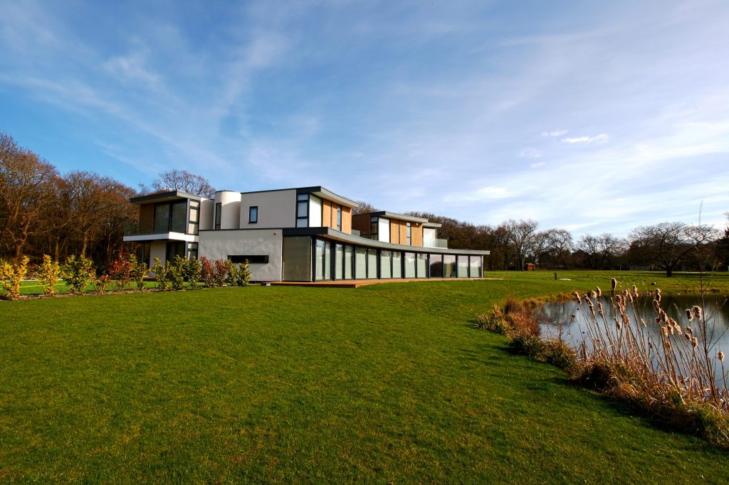 Shows house from the lake with Lutron motorised blinds down