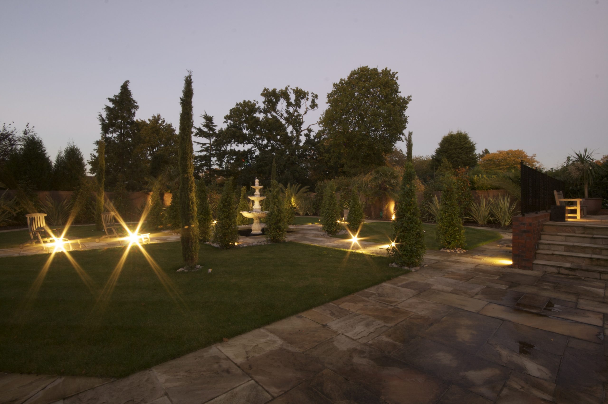 Outside lighting in this Kent home, with low level path lights, accept lights and patio lighting