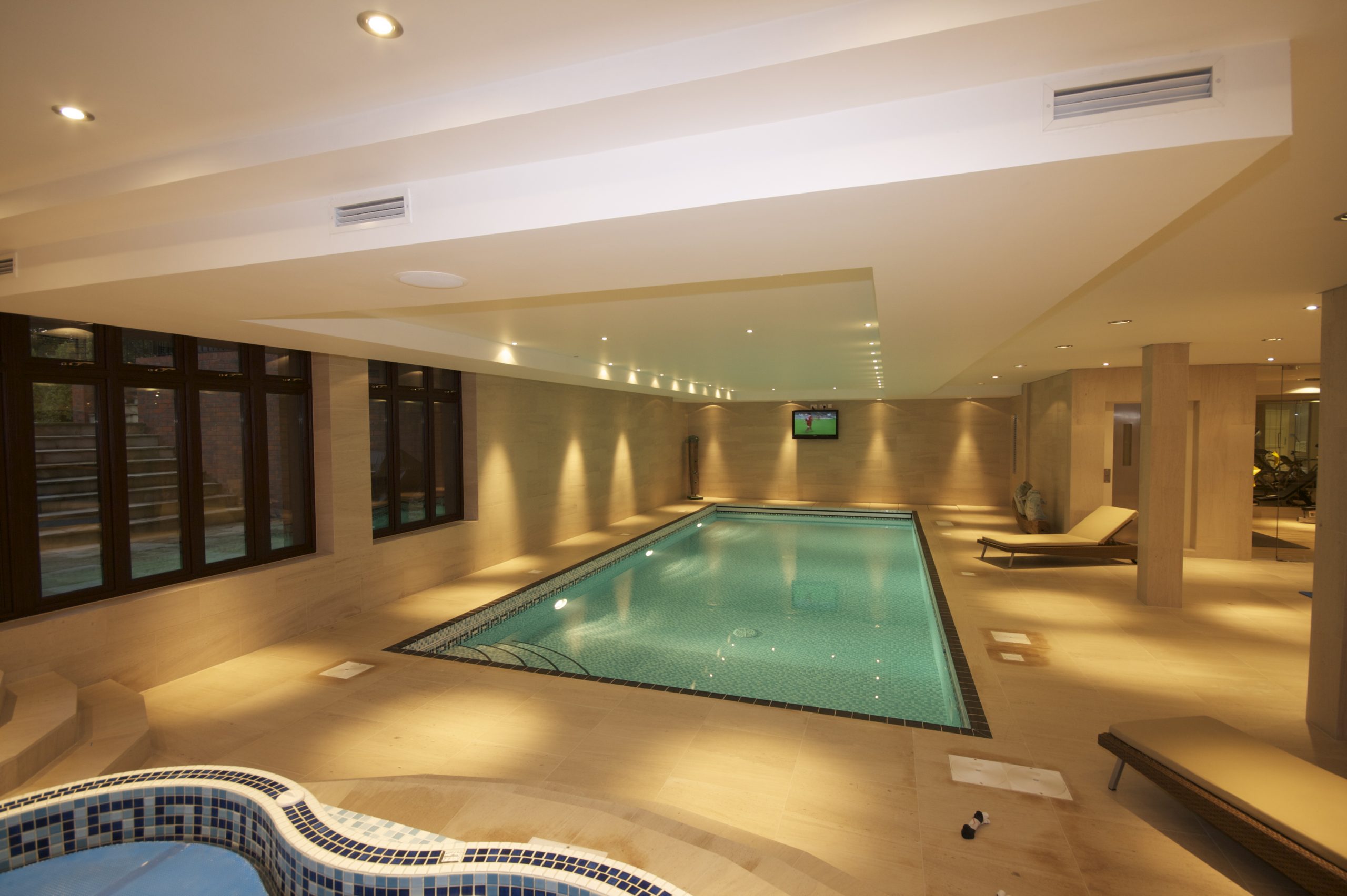 Smart home technology in pool area, shows lighting control, audio system and video distribution.