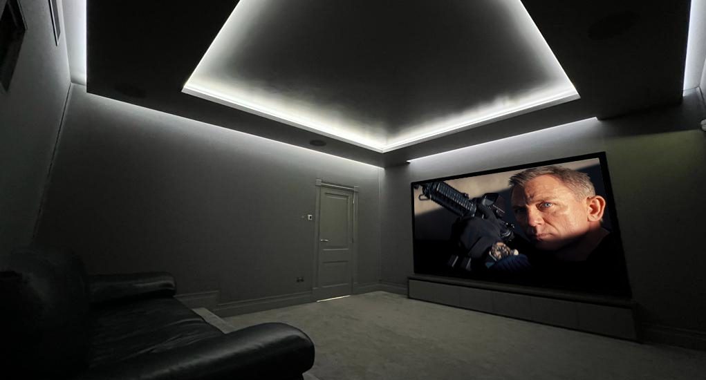 Work of home cinema installer Imagine This. Shows cinema screen, black leather home cinema seats and grey carpet.