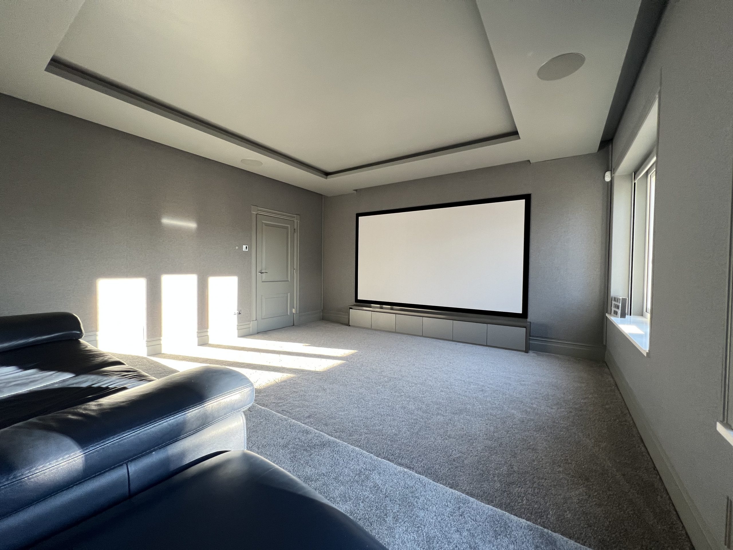 Daytime view of home cinema, with motorised blinds up