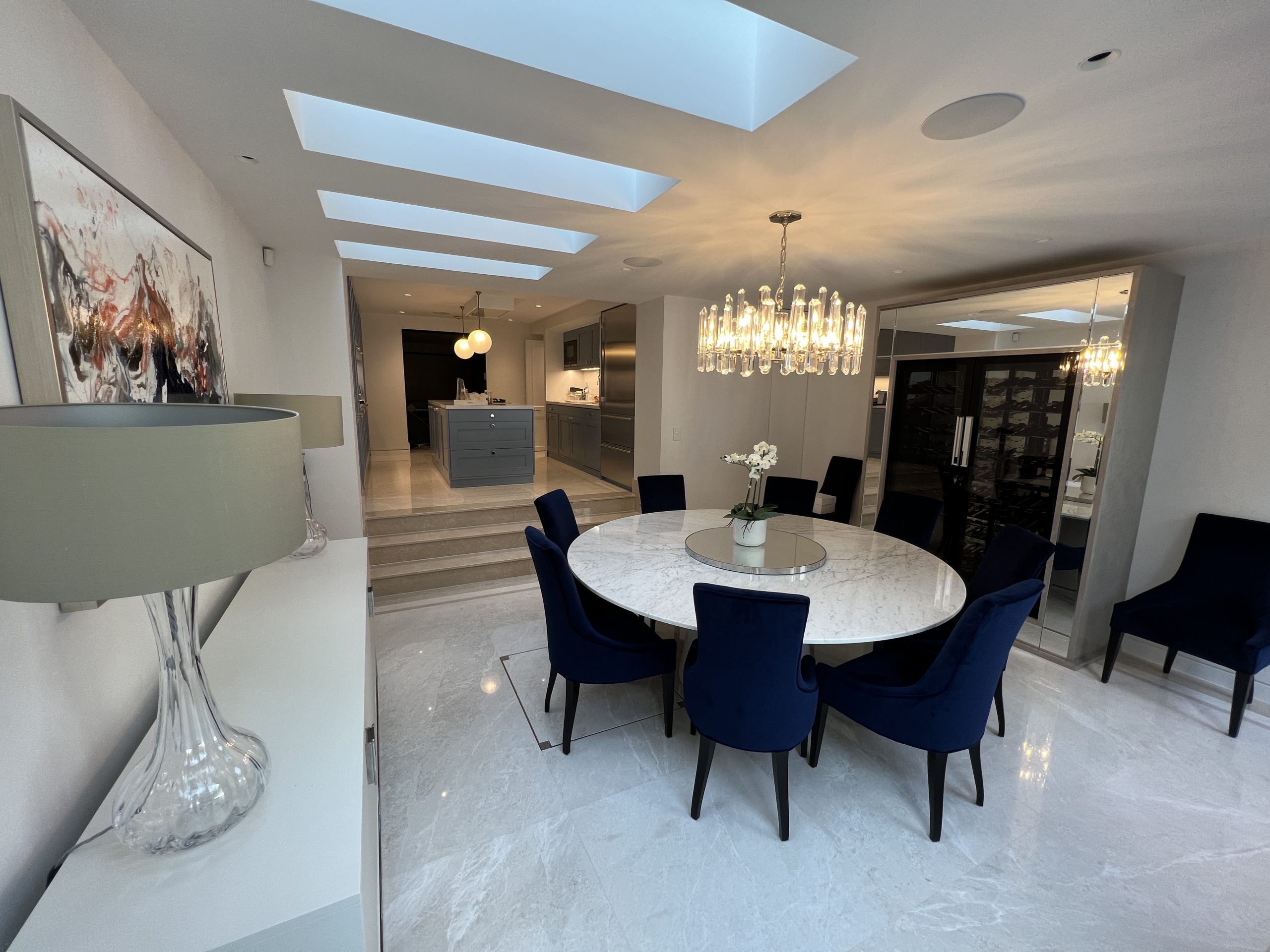 Crestron Control in the dining room and kitchen - shows dining table, light fitting nad in-ceiling speakers.