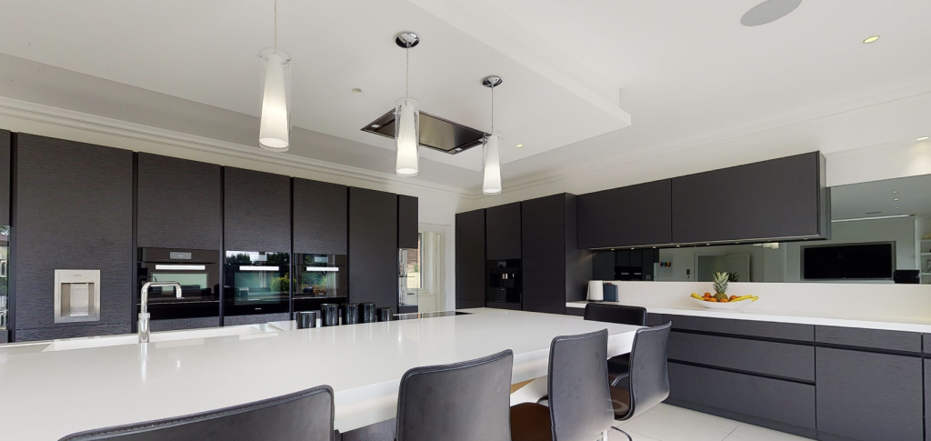 Kitchen with downlights, pendants and in-ceiling speakers. Lutron install.