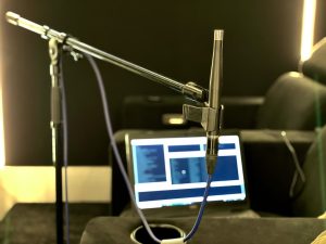 Home cinema room calibration. Shows mic in foreground and laptop in background.