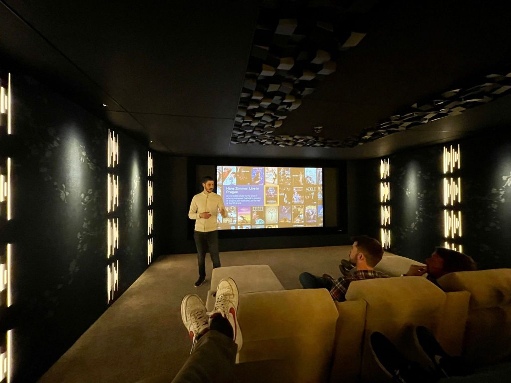 Pulse Cinemas Reference Cinema - our team experienced a home cinema demo. Shows cinema seating and screen.